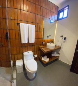 a bathroom with a toilet and a sink at Tapalpa Hotel Casa Colibrí in Tapalpa +12 photos