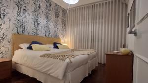 a bedroom with a bed with two laptops on it at Vila Calaça in Funchal