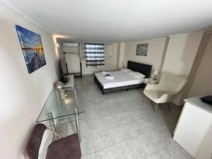 a bedroom with a bed and a table and a chair at Alexandras Studio in Corfu
