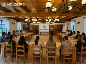 a group of people sitting at tables in a room at Wellness Hotel Holzberg - krytý relaxační bazén, dětský bazén, whirlpool, sauna, restaurace, bowling, venkovní hřiště, herna, pingpong, billiard in Suchá Rudná +79 photos