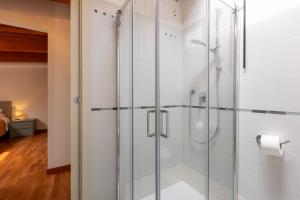 a glass shower in a bathroom with a toilet paper roll at AcquaRoom in Montesilvano Marina