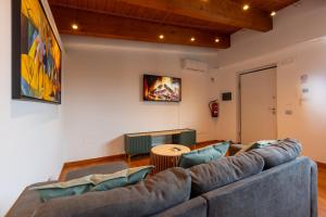a living room with a couch and a fireplace at AcquaRoom in Montesilvano Marina