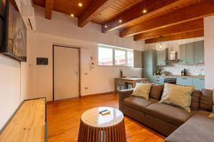 a living room with a couch and a table at AcquaRoom in Montesilvano Marina