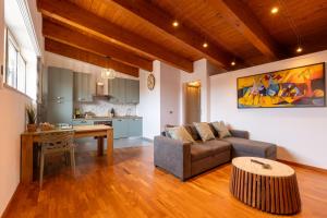 a living room with a couch and a table at AcquaRoom in Montesilvano Marina +18 photos