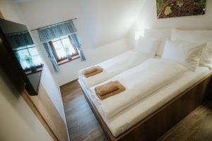 a large bed with white sheets and pillows in a room at U Stařečka in Hovorany