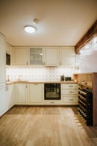a kitchen with white cabinets and a wooden floor at U Stařečka in Hovorany