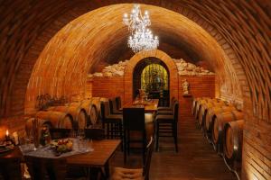 a wine cellar with tables and chairs and a chandelier at U Stařečka in Hovorany