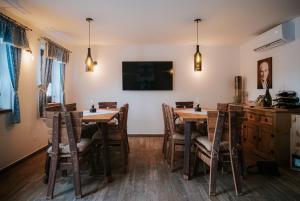 a dining room with wooden tables and chairs at U Stařečka in Hovorany