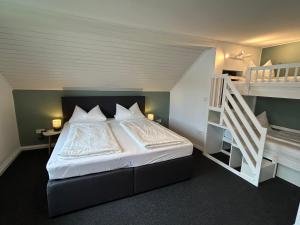 a bedroom with a bed and a bunk bed with a ladder at Ferienhaus Luisl & Hilde in Unterammergau +49 photos