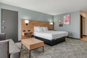 a hotel room with a bed and a couch at Best Western Tomah Hotel in Tomah