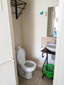 a bathroom with a toilet and a sink at Orison Managua in Managua