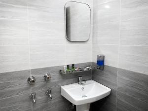 a bathroom with a sink and a mirror on the wall at Hotel Grand Darbar in Barisāl +16 photos