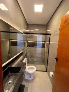 a bathroom with a toilet and a glass shower at Cascata Boutique Hotel in Várzea da Palma
