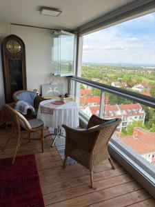 a room with a table and chairs and a large window at Helle Wohnung in Fürth in Fürth