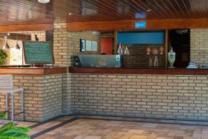 a brick wall with a bar in a restaurant at Hotel Areias Belas in Maragogi +29 photos