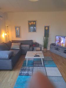 a living room with a couch and a coffee table at Schwedenhaus-Nykroppa in Nykroppa