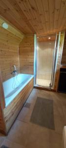 a sauna with a tub in a wooden wall at Schwedenhaus-Nykroppa in Nykroppa +20 photos