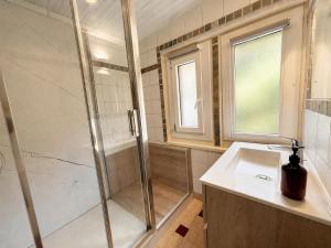 a bathroom with a shower and a sink at Chalet Génépi in Montriond