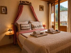 a bedroom with a bed with towels on it at Chalet Génépi in Montriond
