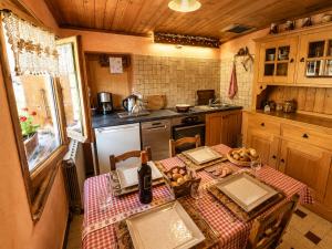 a kitchen with a table with a table cloth at Chalet Génépi in Montriond