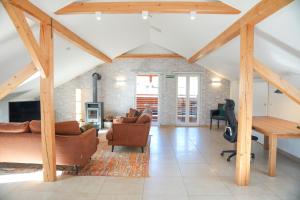 a living room with wooden beams and a fireplace at Arber Lofts in Bayerisch Eisenstein in Bayerisch Eisenstein