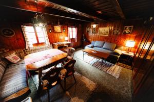 a living room with a table and a couch at Almhütte am Steirischen Seeberg in Turnau
