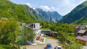an aerial view of a village in the mountains at Hotel Familja Çuni Theth in Theth