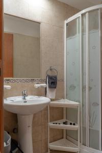a bathroom with a sink and a shower at Miranda's Apartments in Koskinou +133 photos
