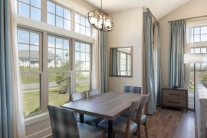 a dining room with a table and some windows at Massanutten Resort in Massanutten