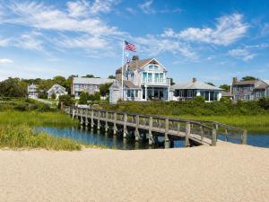 a house with an american flag on a dock at Colonial Acres Resort in Yarmouth