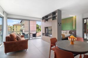 a living room with a table and a bedroom at La Casetta di Cannero by Residenza La Zagara in Cannero Riviera