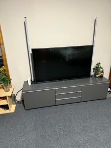 a flat screen tv sitting on a entertainment center at YKI Room in Oulu