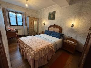 a bedroom with a bed and a table and a window at Casa Rural Garzibaita in Sumbilla