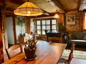 a living room with a wooden table with a plant on it at The Village in Anzat-le-Luguet