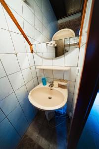 a bathroom with a white sink and a mirror at Almhütte am Steirischen Seeberg in Turnau