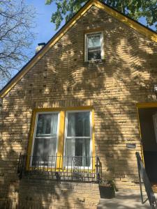 a brick house with two windows and a balcony at Logans Lodge in Minneapolis