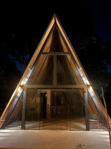 a triangular house with lights on it at night at Chalés parada ideal in Guapimirim