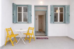 two chairs and a table in a room with a window at Mirtilo - Local Style, 1 Min from Main Beach in Kardamaina