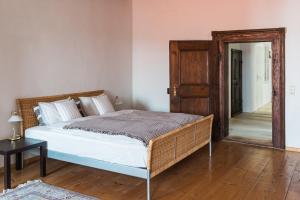 a bedroom with a bed and a mirror and a door at Historisches Bürgerhaus Hartlschuster in Neufelden