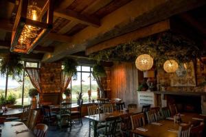 a restaurant with tables and chairs in a room at The Nest at The Woodmans in Whickham