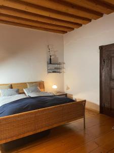 a bedroom with a bed in a room with wooden ceilings at Historisches Bürgerhaus Hartlschuster in Neufelden