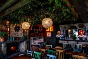 a restaurant with tables and chairs and a fireplace at The Nest at The Woodmans in Whickham +2 photos