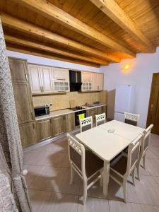 a kitchen with a table and chairs in a room at Skyline Villa Boge in Bogë
