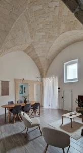 a large living room with a table and chairs at La Loggia, Historic Center in Grottaglie