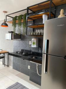 a kitchen with a stainless steel refrigerator and a counter at AliReserva Luxury Suites in Palmas