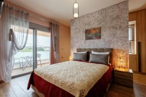 a bedroom with a bed and a large window at Valentina's Luxe Apartment in Mastihari