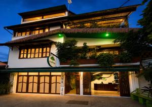 a building with a lit up facade at night at Eco Hotel El Refugio Boutique in Leticia