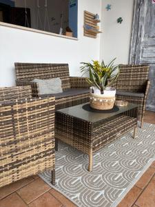 a patio with two wicker chairs and a table at Vista mare Fiumicino-Beach&Fly Stay in Fiumicino +22 photos