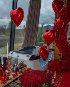 a table with red roses and a car with hearts at View Apartament Kasprowy Wierch Premium DeLuxe & SPA in Kościelisko +94 photos