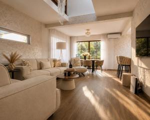 a living room with a couch and a table at Villa Alera in Dobra Voda